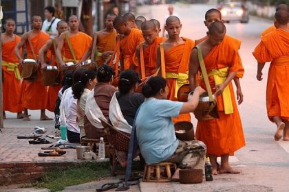 alms giving - best laos tours