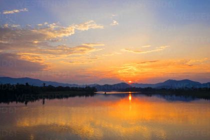 sunset over perfume river in hue